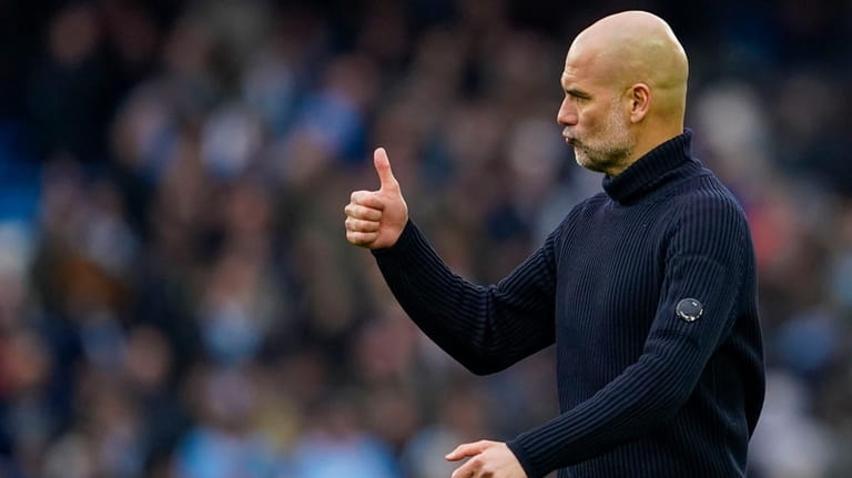Manchester City's head coach Pep Guardiola gestures at the end...