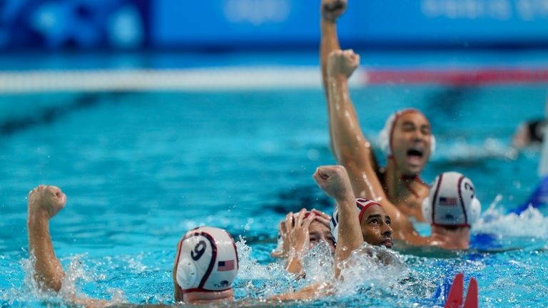 United States' team celebrates after winning the men's water polo...