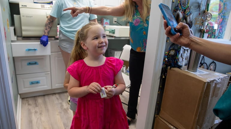 Ella McShea, 5, of Lynbrook, steps out of the piercing room...