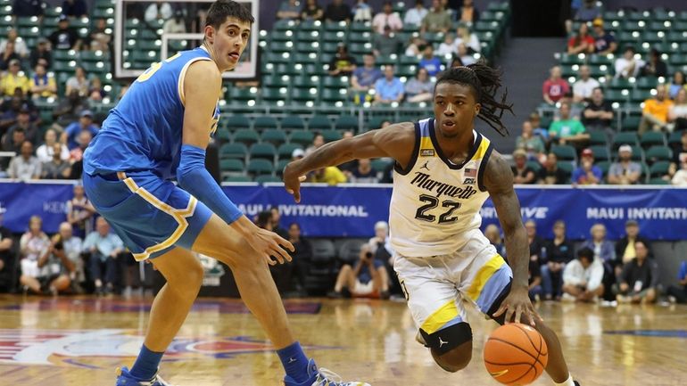 Marquette guard Sean Jones (22) gets past UCLA forward Berke...