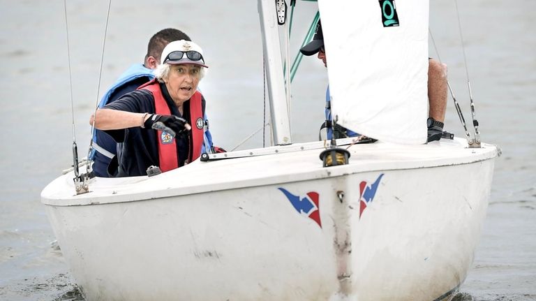 Aboard an Ideal 18 sailboat, sailing instructor Penny Van Riper...