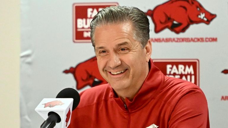 John Calipari answers questions from reporters during a press conference...