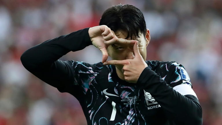 Son Heung Min of South Korea reacts after scoring a...