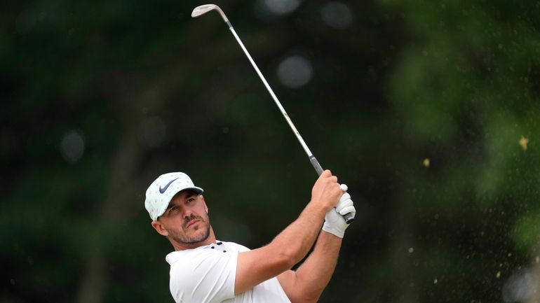 Brooks Koepka watches his shot on the 11th hole during...