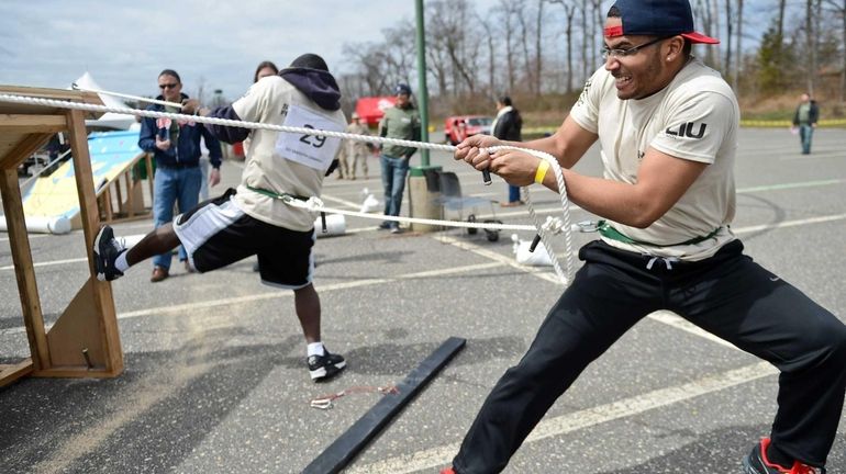 Shaun Jackson, a senior criminal justice major, pulls a rope...