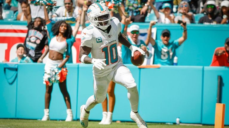 Miami Dolphins wide receiver Tyreek Hill (10) scores in the...