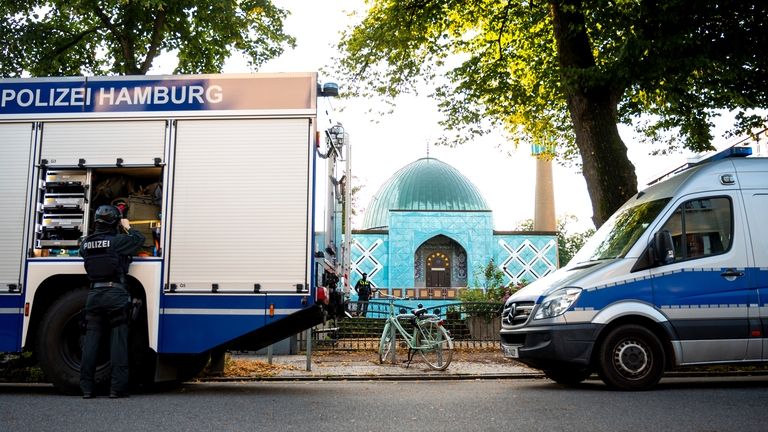 Police officers stage outside the Islamic Center Hamburg with the...