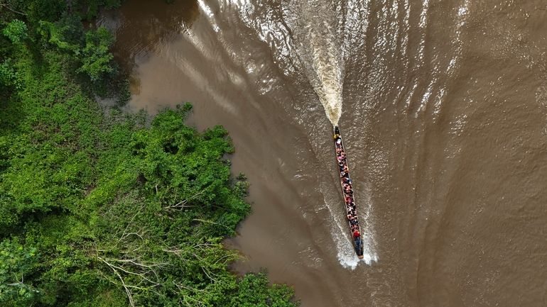 Migrants travel on a boat to Lajas Blancas, Panama, Friday,...