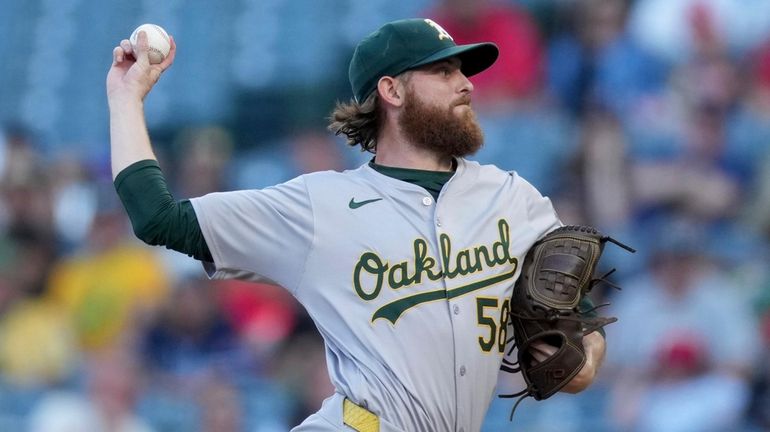 Athletics starting pitcher Paul Blackburn throws during the first inning...