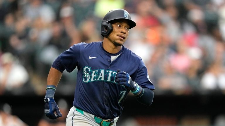 Seattle Mariners' Jorge Polanco watches his home run off Chicago...