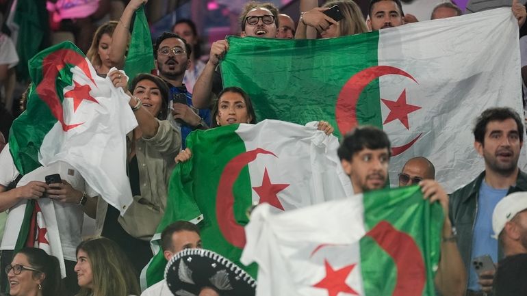 Algeria fans cheer as Algeria's Imane Khelif prepares to fight...