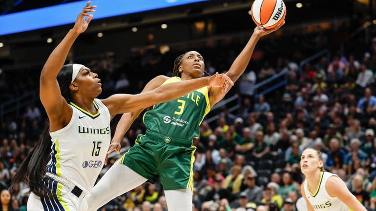 Seattle Storm's Nneka Ogwumike makes a move around Dallas center...