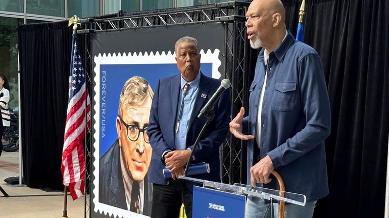 Jamaal Wilkes, left, listens as Kareen Abdul-Jabbar speaks at the...