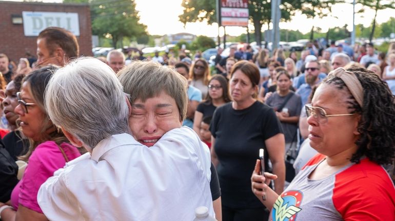 Grieving mourners attend the candlelight vigil.