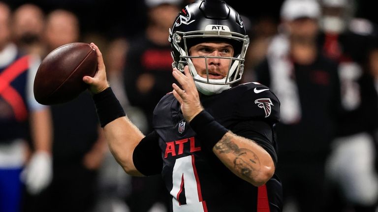 Atlanta Falcons quarterback Taylor Heinicke (4) works in the pocket...