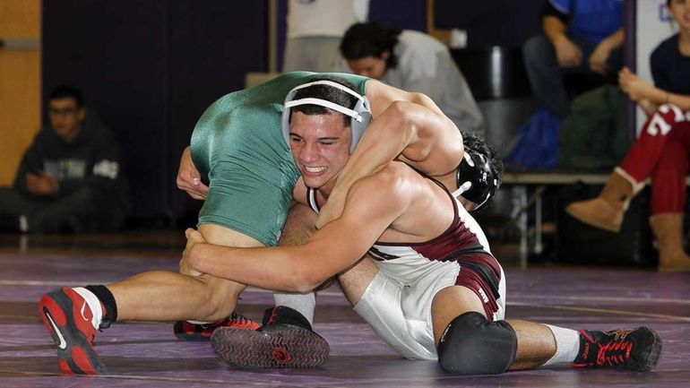 Deer Park's Zach Lugo struggles to control Brentwood's Alexis Blanco's...