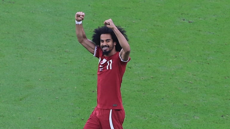 Qatar's Akram Afif celebrates after scoring a goal during the...