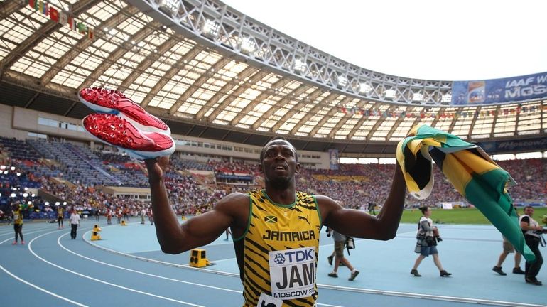 Jamaica's Usain Bolt celebrates after winning the men's 4x100 meter...