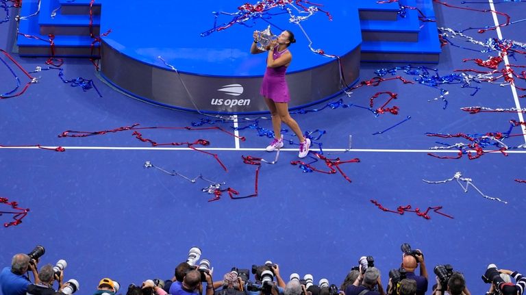 Aryna Sabalenka, of Belarus, kisses the trophy after winning the...