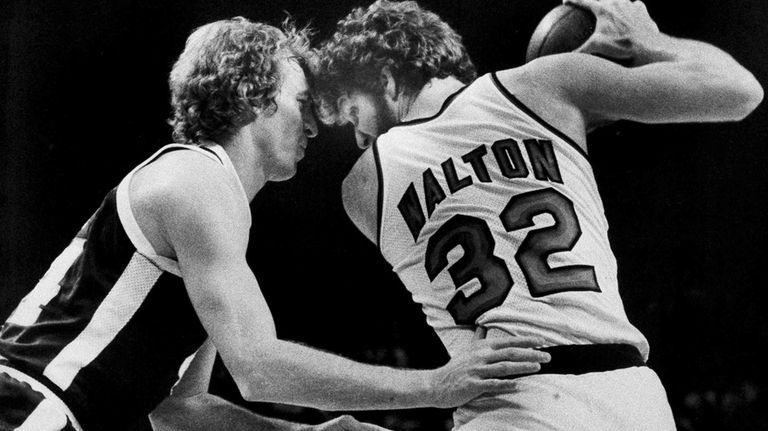 Denver Nuggets' Dan Issel, left, guards Portland Trail Blazers' Bill...