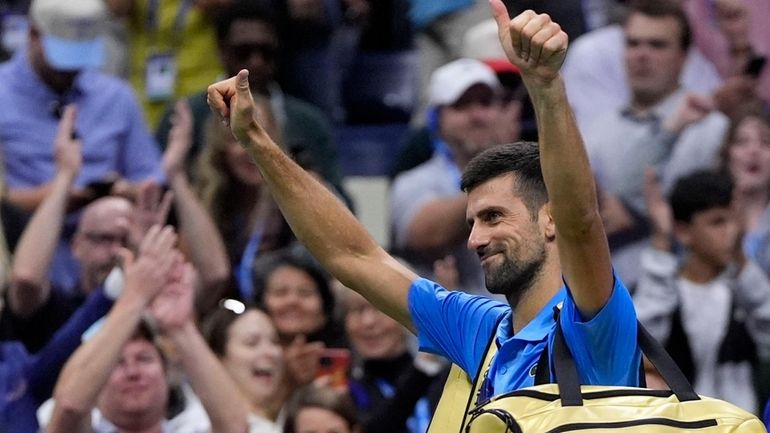 Novak Djokovic, of Serbia, reacts against Alexei Popyrin, of Australia,...