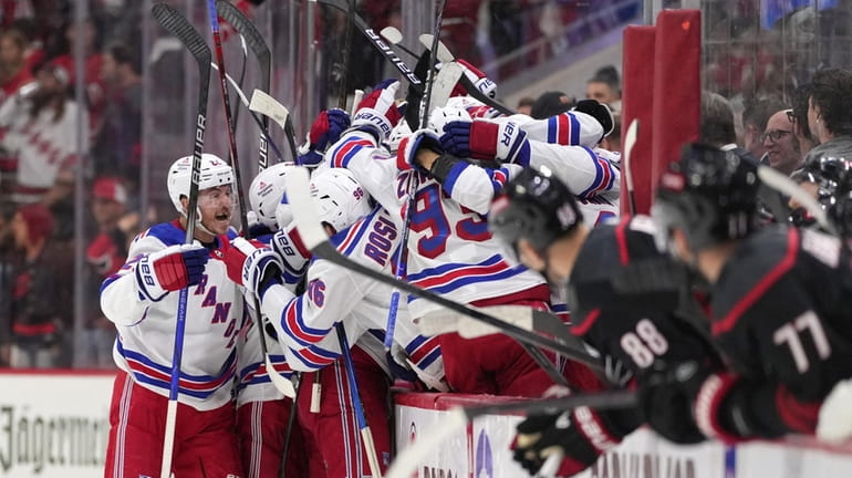 Members of the Rangers celebrate an empty net goal against the...