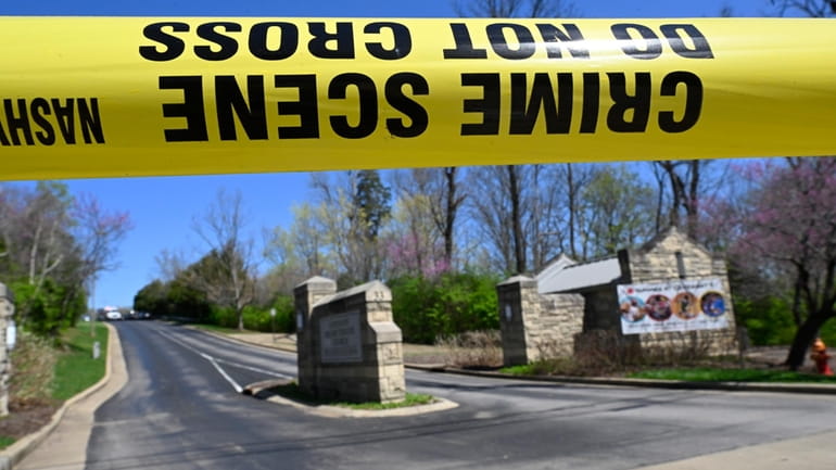 A police crime scene tape is seen at the entrance...