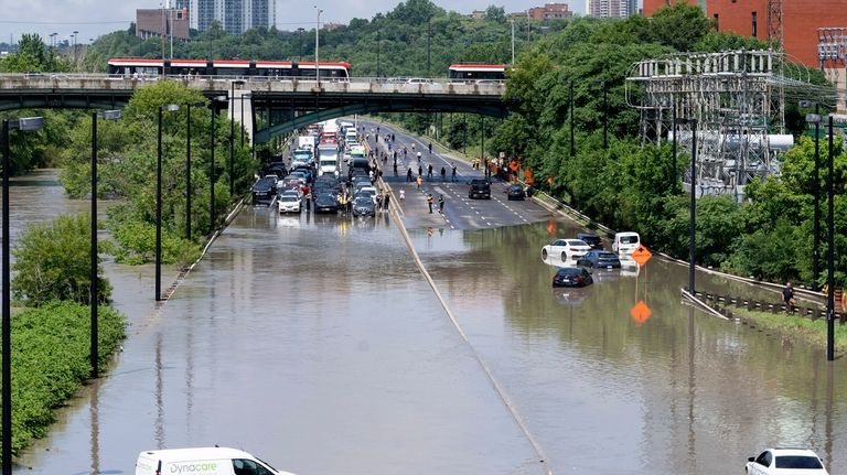 Cars are partially submerged in flood waters in the Don...