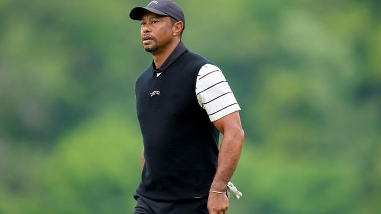 Tiger Woods walks to the fifth hole during a practice...