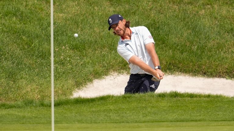 Tommy Fleetwood, of Britain, chips out of a bunker to...