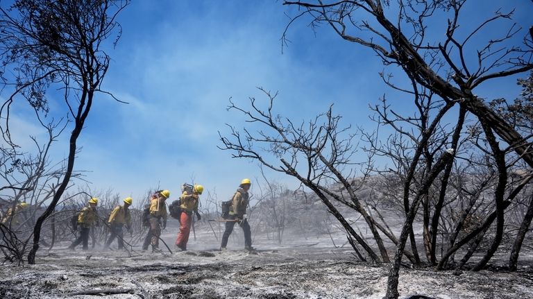 Members of Riverside County Cal Fire monitor for hot spots...