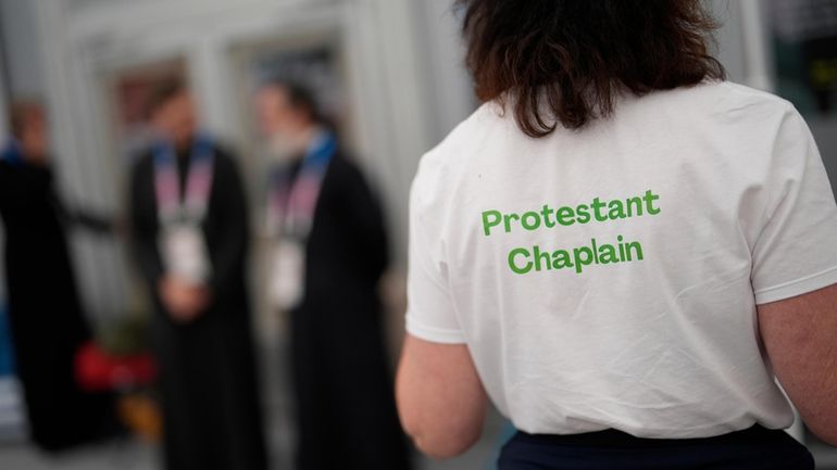 A woman wears a t-shirt to help distinguish religions in...