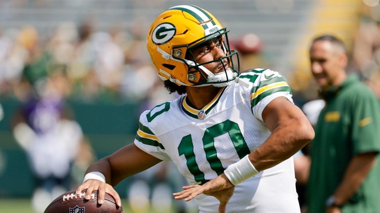 Green Bay Packers' Jordan Love warms up before a preseason...