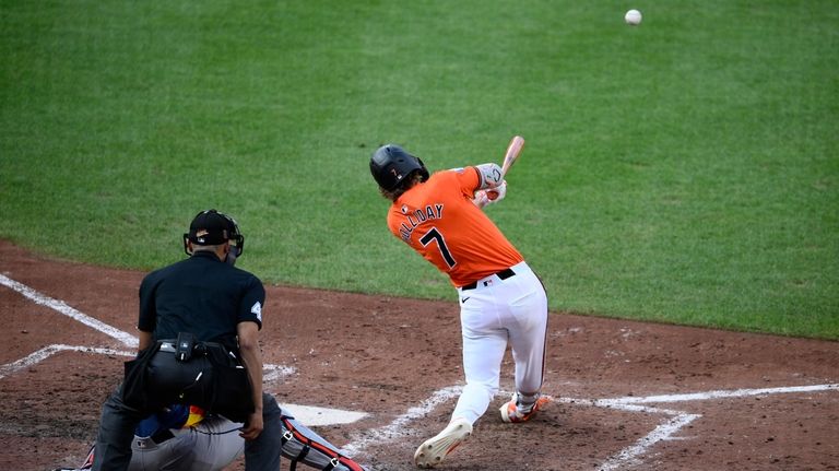 Baltimore Orioles' Jackson Holliday, right, doubles in three runs during...