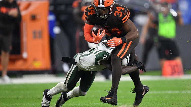 Carlos Hyde of the Browns gets wrapped up by Morris...
