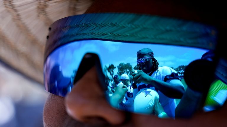 Dallas Cowboys offensive tackle Tyler Guyton is seen signing autographs...