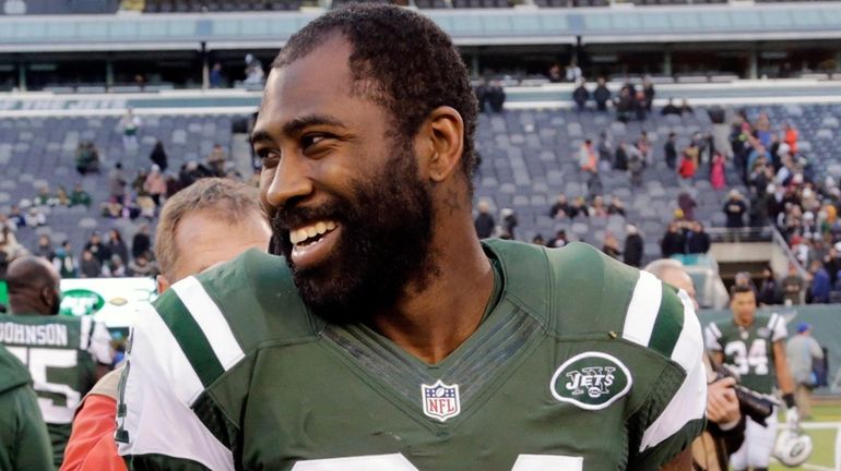 Jets cornerback Darrelle Revis walks on the field after an...