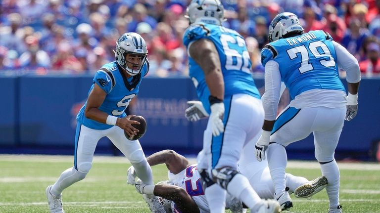 Carolina Panthers quarterback Bryce Young (9) eludes Buffalo Bills defensive...