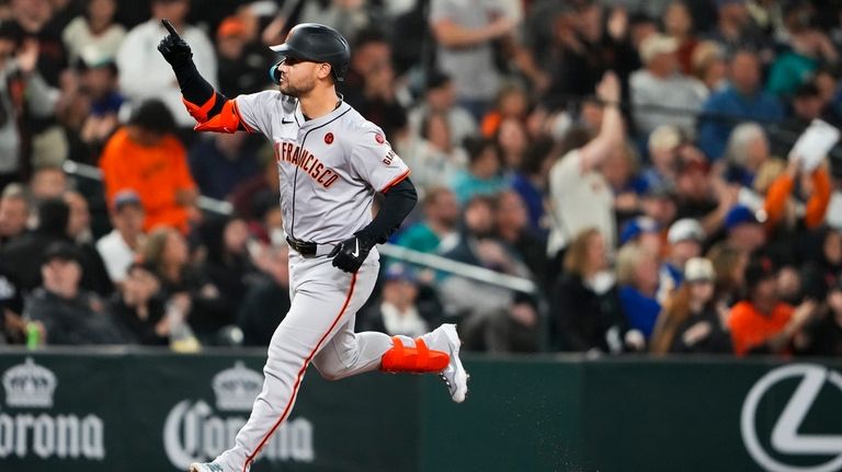 San Francisco Giants' Michael Conforto runs the bases after hitting...