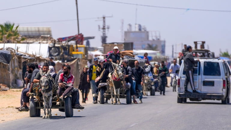 Displaced Palestinians arrive in Deir al Balah in central Gaza...