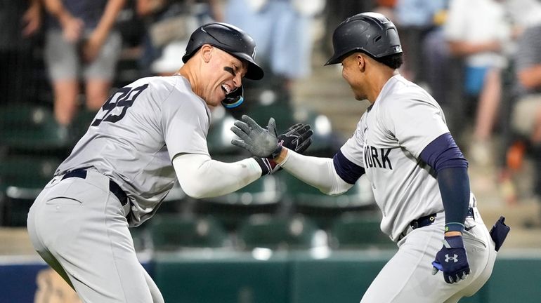 The Yankees' Juan Soto, right, celebrates his home run off...