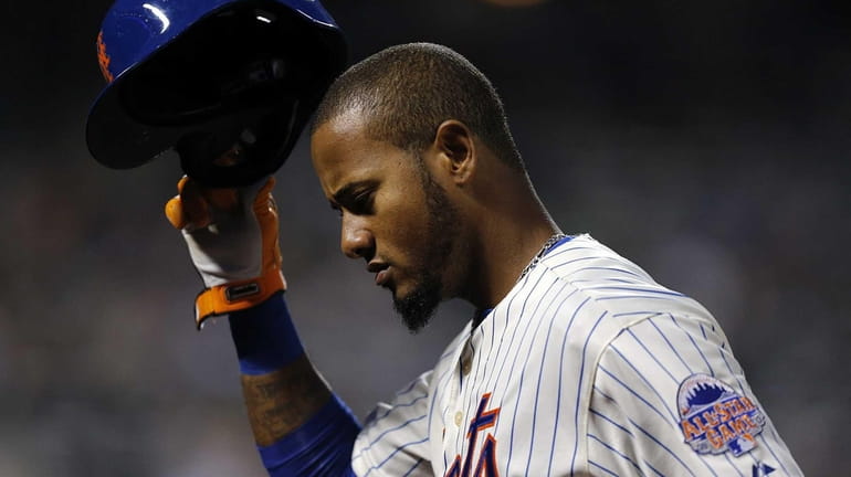 Mets center fielder Jordany Valdespin returns to the dugout after...