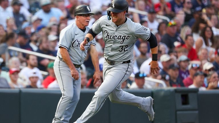 Chicago White Sox's Gavin Sheets (32) scores on a triple...