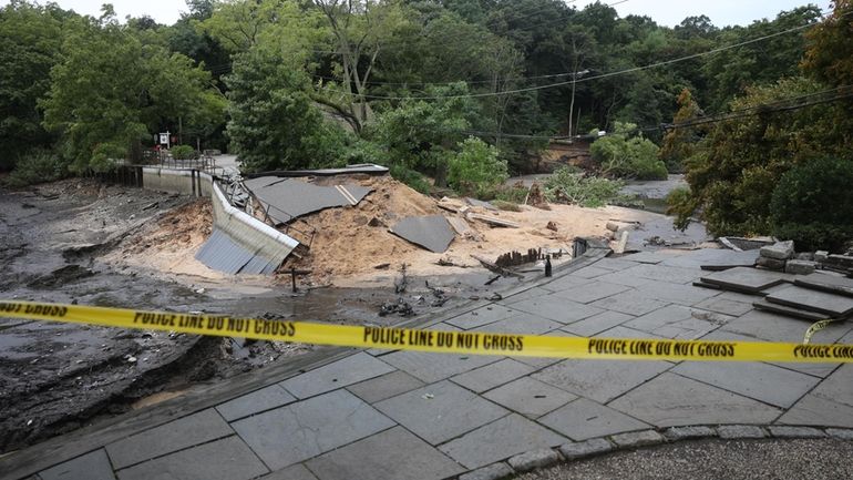 Damage seen on Tuesday after flooding rains caused the Mill...