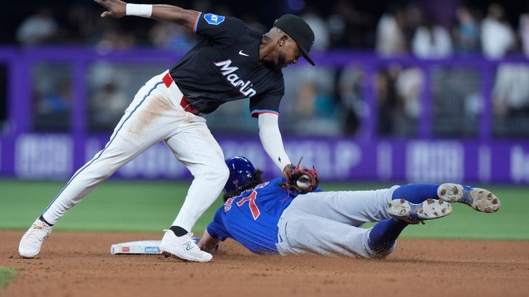 Miami Marlins second base Vidal Bruján, left, is unable to...