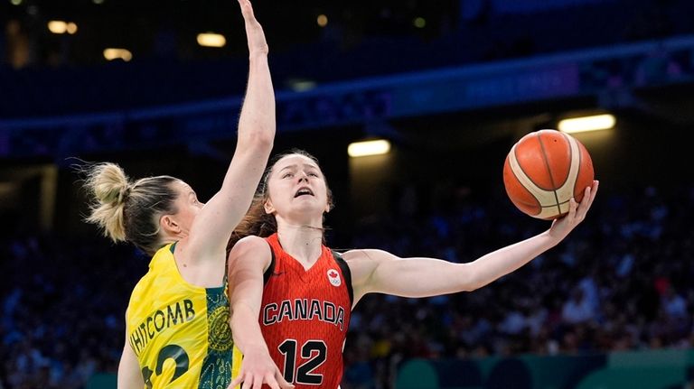 Canada's Syla Swords, right, shoots as Australia's Sami Whitcomb defends...