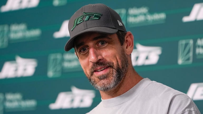 New York Jets quarterback Aaron Rodgers talks to reporters after...