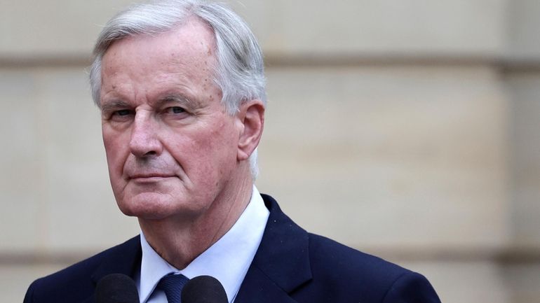 New French prime minister Michel Barnier looks on right during...