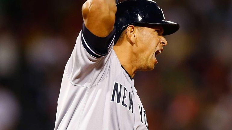 Alex Rodriguez reacts after hitting a solo home run in...