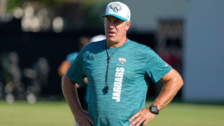 Jacksonville Jaguars head coach Doug Pederson watches players practice during...